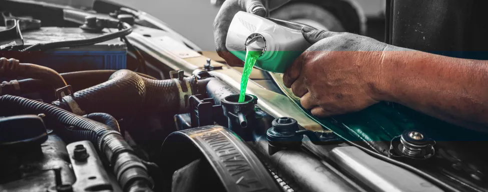 BG Maintenance Service In Sterling, VA At Honest Tom Care. A hand pulling out a dipstick to check a car's engine oil level during routine maintenance.