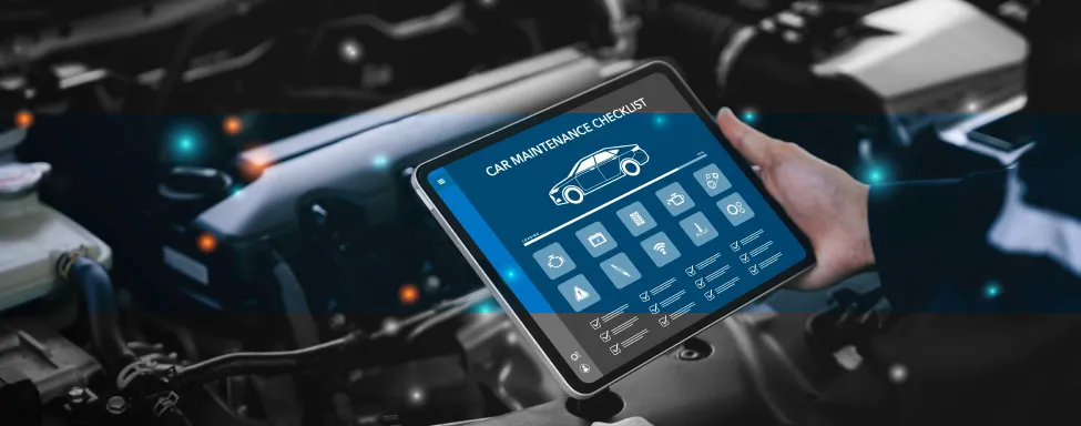 Engine Diagnostics & Repair In Sterling, VA At Honest Tom Care. A mechanic using a handheld diagnostic tool or tablet connected to a car's engine.