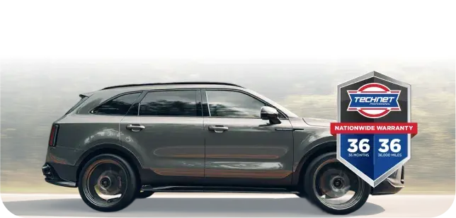 Auto Repair Warranty In Sterling, VA At Honest Tom Care. A grey SUV driving down a road with a forest in the background. At the right side is the official TechNet Professional Nationwide Warranty logo,